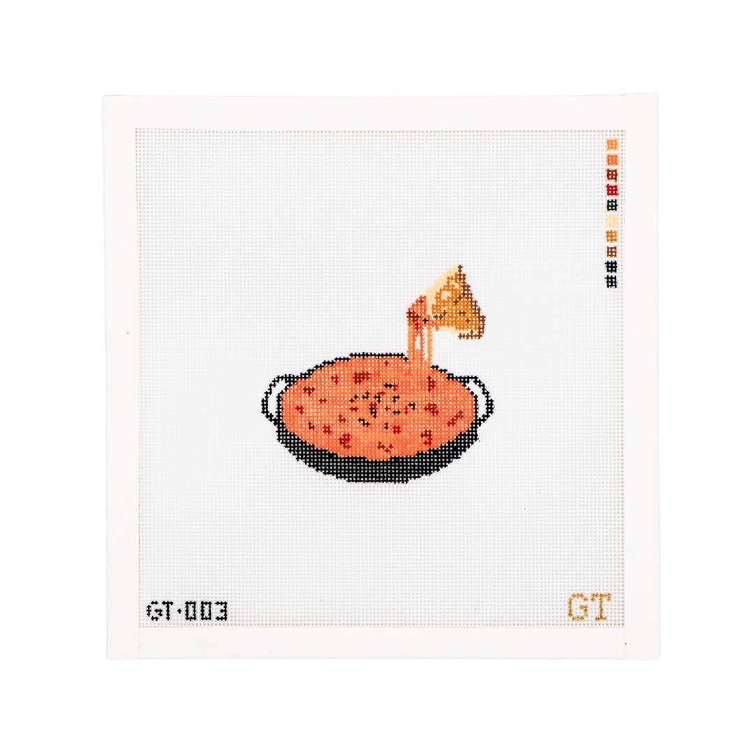 Needlepoint Canvas featuring queso in a cast iron skillet. A tortilla chip illustrates a cheese pull. 18 mesh needlepoint canavs.