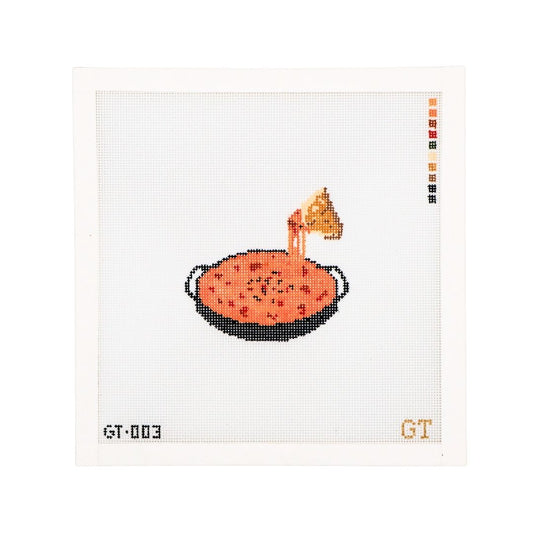 Needlepoint Canvas featuring queso in a cast iron skillet. A tortilla chip illustrates a cheese pull. 18 mesh needlepoint canavs.