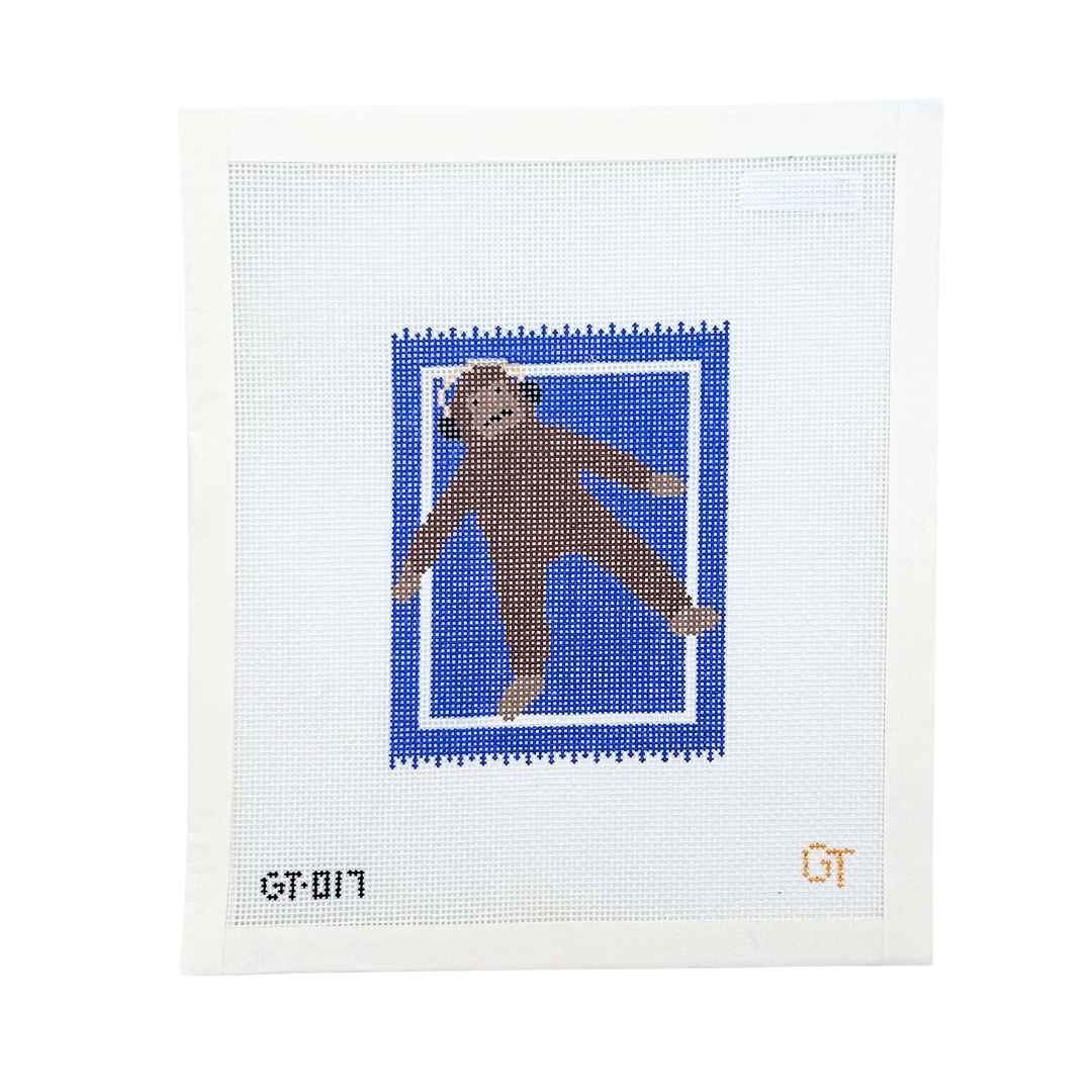 Monkey wearing headphones laying on a blue rug