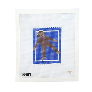 Monkey wearing headphones laying on a blue rug